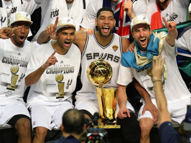 The San Antonio Spurs celebrate with the Larry O'Brien NBA Championship Trophy after the Spurs defeated the Miami Heat 107-84 in Game 5 of the NBA Finals to win the NBA Finals Championship, June 15, 2014 in San Antonio,Texas.  From left are: MVP Kawhi Leonard, Tony Parker, Tim Duncan, Manu Ginobili and Patty Mills.   The Spurs won the best of seven series 4-1.  AFP PHOTO / Robyn BeckROBYN BECK/AFP/Getty Images